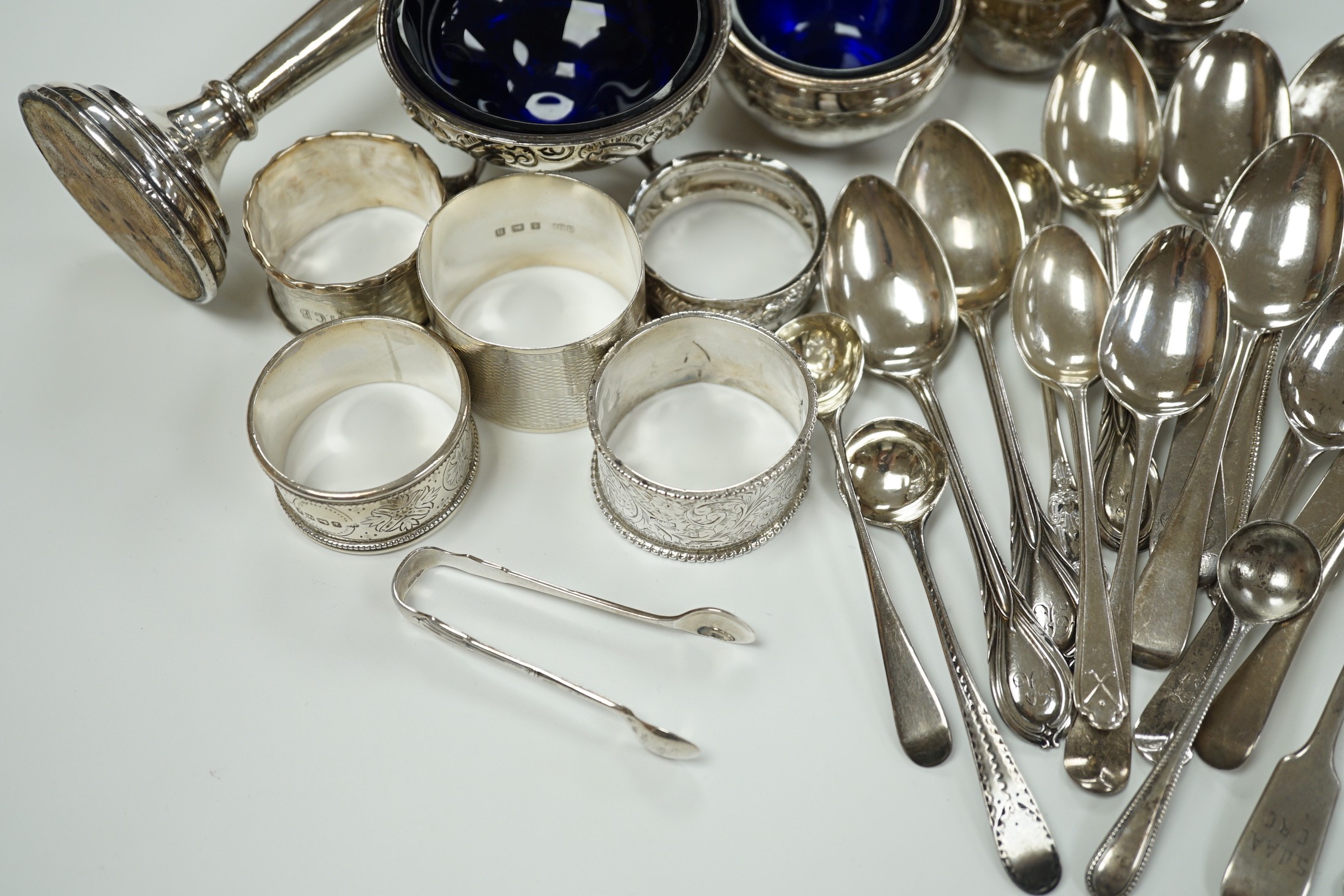 A small collection of assorted small silver including five napkin rings, a posy vase, two pepperettes, two small salts including Irish(marks very rubbed) and twenty eight small spoons.